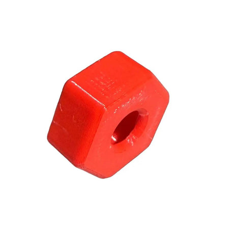 Red plastic hexagonal block with a central hole on a white background