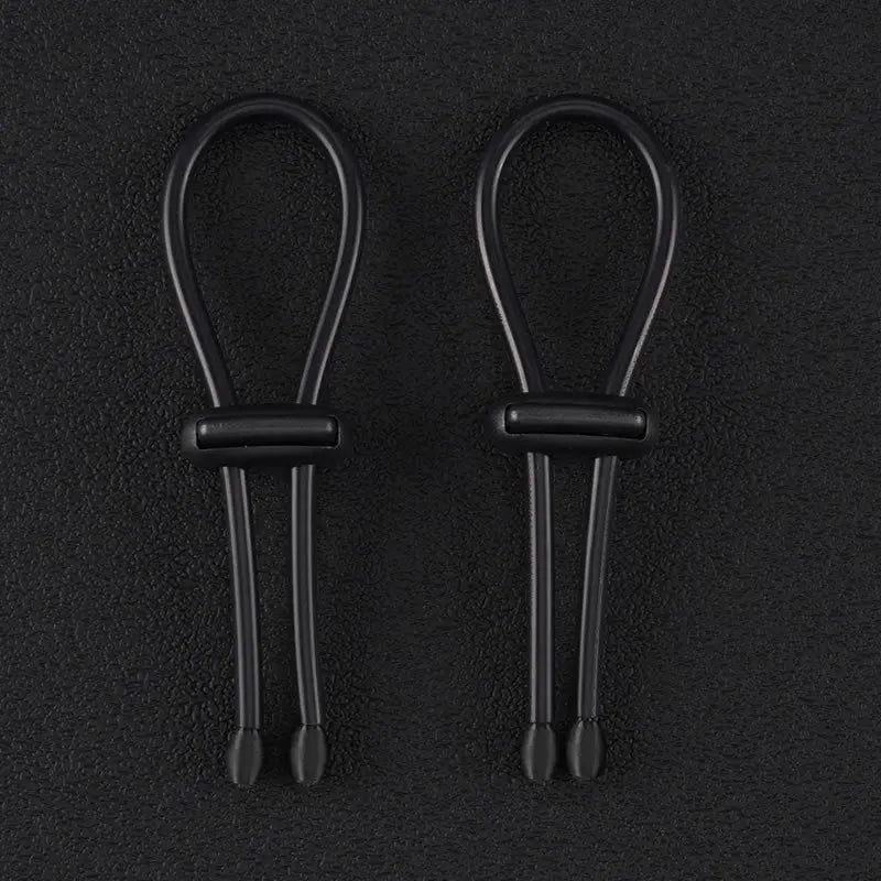 Pair of 4mm conductive rubber loops with elasticated conductive core on a dark background